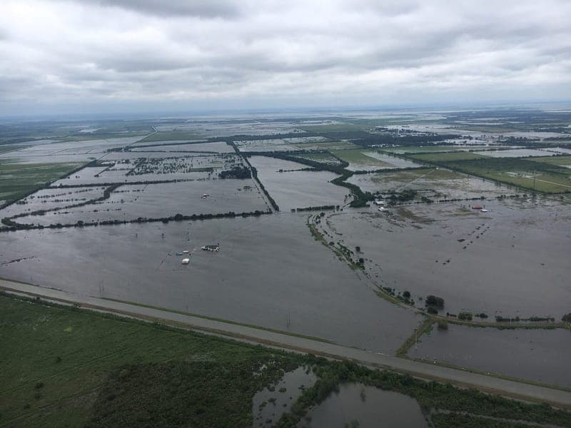 Aerial view of farmland and homes under floodwater